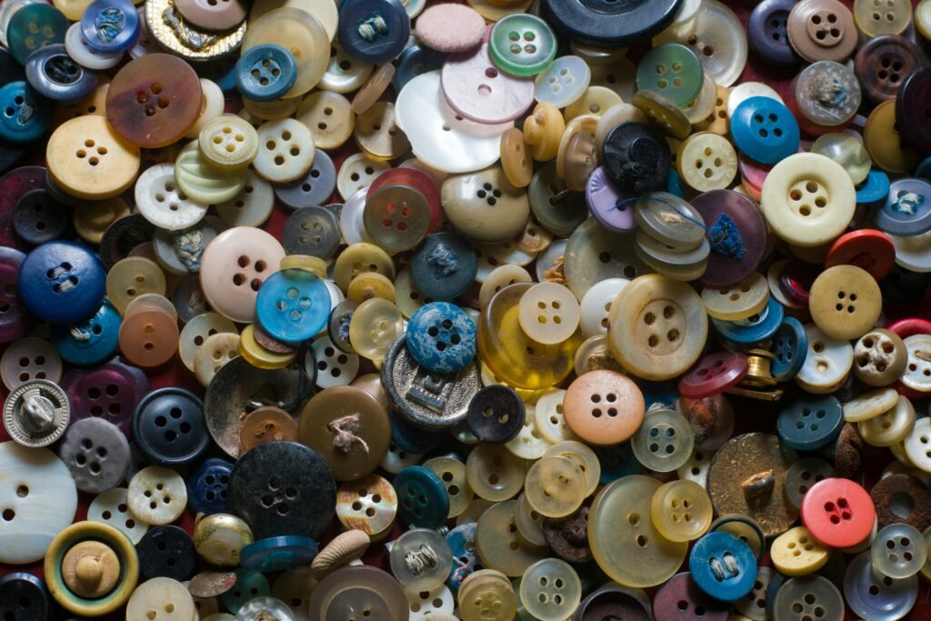 A close-up view of various colorful vintage buttons scattered for crafting and textile projects.